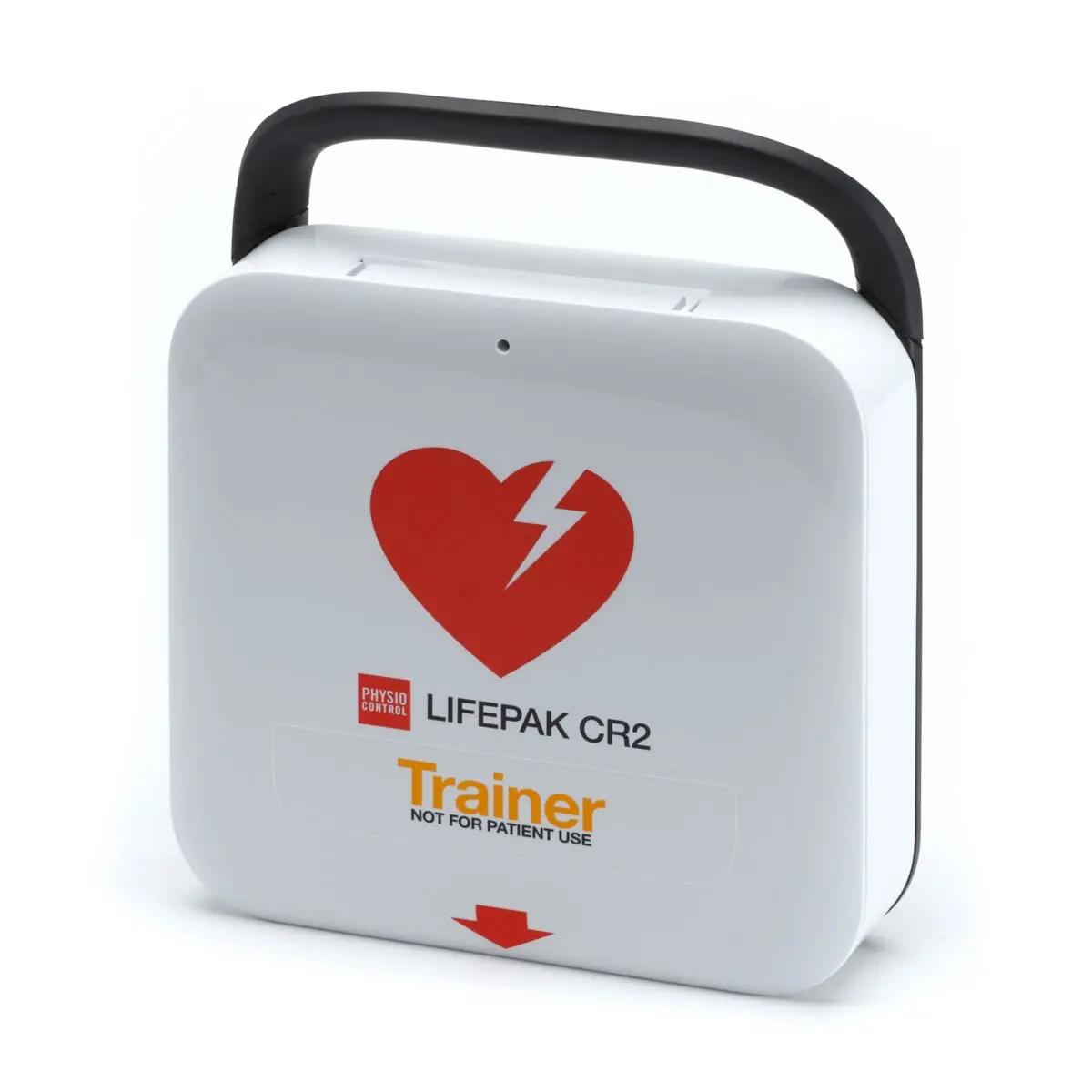 Ein kompaktes Trainingsgerät LIFEPAK CR2 mit schwarzem Griff, rotem Herzsymbol, vorprogrammierten Trainingsszenarien und Kindermodus.