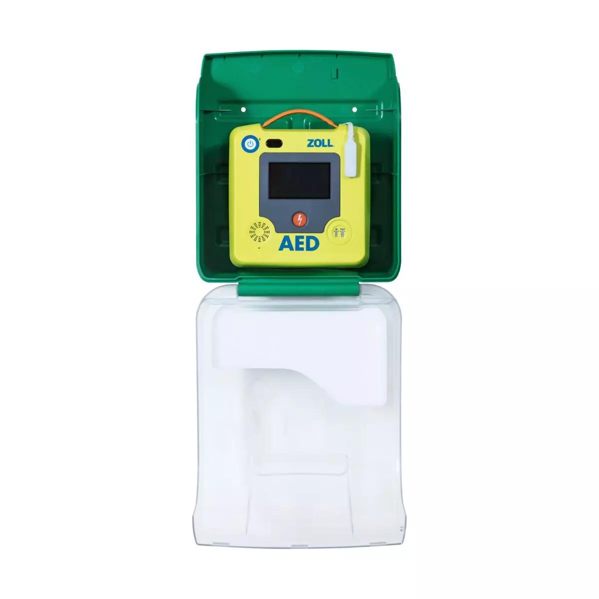 Ein AED-Wandschrank AIVIA IN 100 mit grünem Gehäuse, transparenter Front und gelbem Defibrillator mit grauem Display und orangefarbenem Knopf.