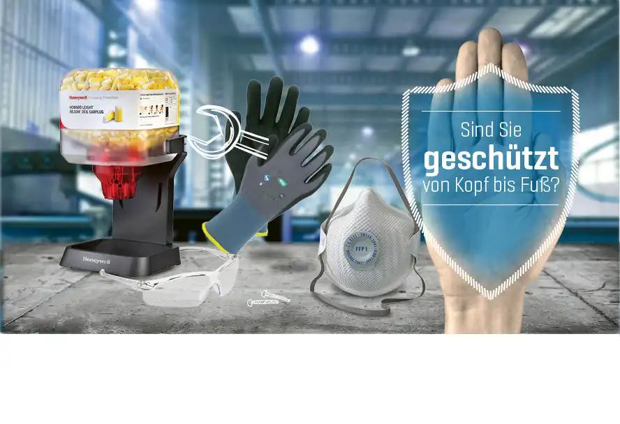 Honeywell Spender mit gelben Granulat, daneben schwarze Handschuhe, weiße FFP2 Maske und Hand mit blauem Gesichtsschutz