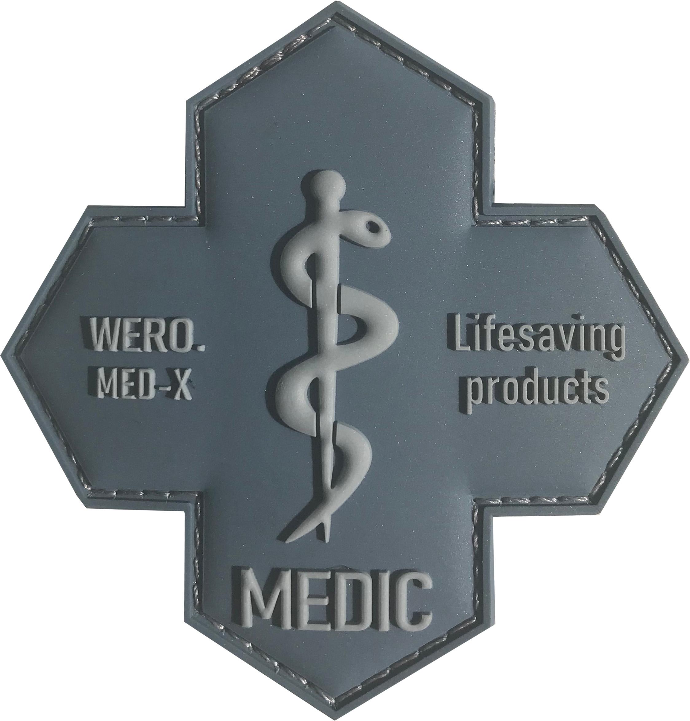 Kreuzförmiger WERO MED-X Patch aus grauem Rubber mit gesticktem Caduceus, schwarzer Schrift "MEDIC" und umlaufender Naht.