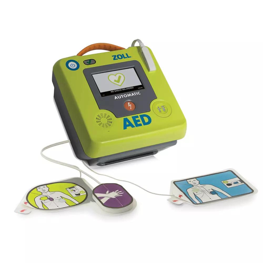 Defibrillator-Set ZOLL® AED 3, Vollautomat in Grün-Blau mit großem Display, gelbem Griff und gekennzeichneten Elektrodenpads für Erwachsene und Kinder.