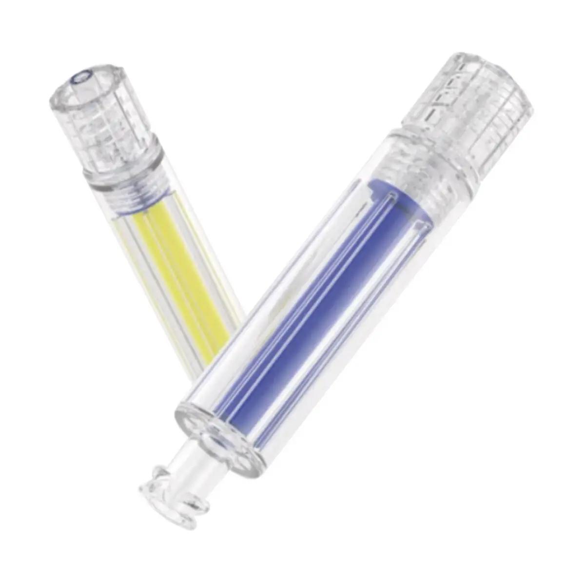 Zwei transparente Capnospot® Pneumothorax Dekompressionsindikator Zylinder, einer gelb, einer blau, liegen überkreuzt und enthalten Flüssigkeit.