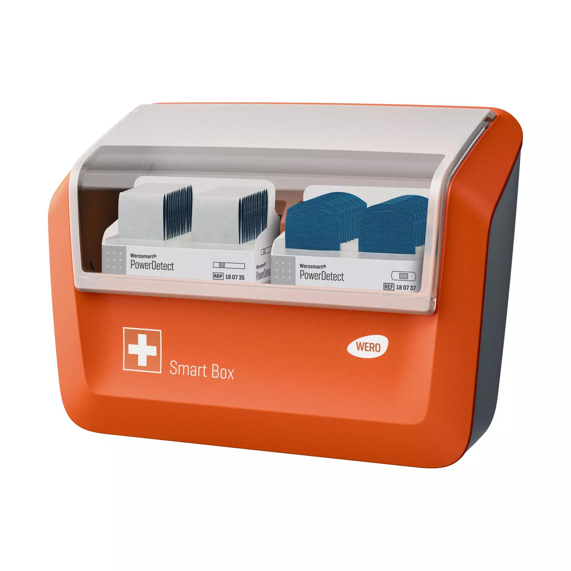 Eine offene WERO Smart Box® Pflasterspender gefüllt mit PowerDetect Pflasterstrips & Fingerpflaster zeigt zwei Fächer mit blauen, detektierbaren Pflasterpads aus Textilgewebe.