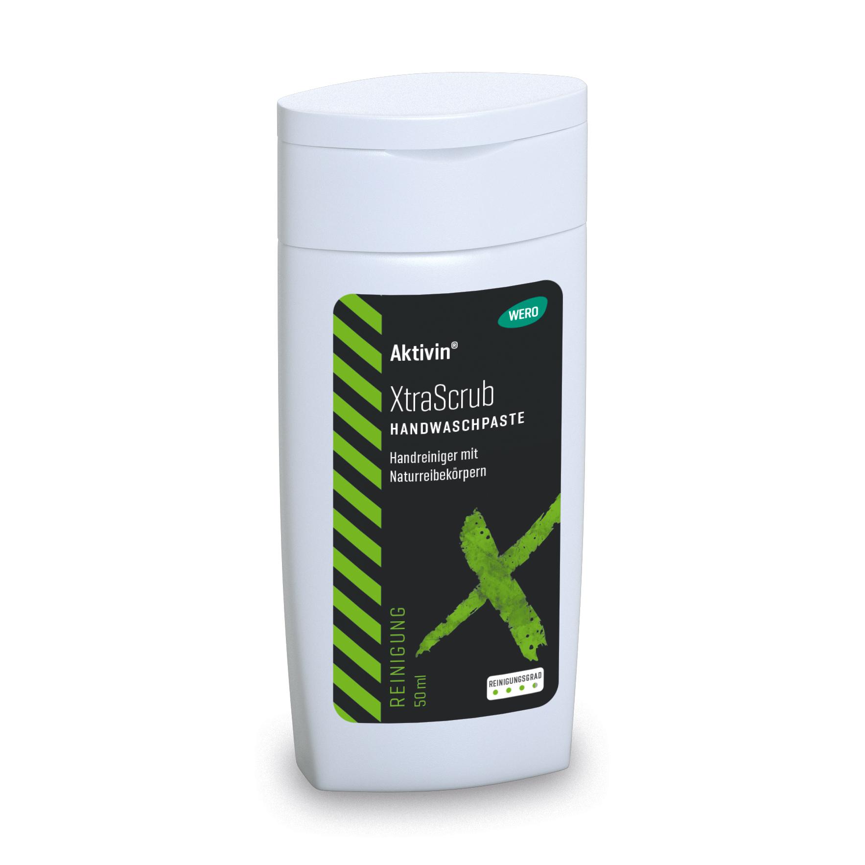 Weiße Flasche Hautreinigung Aktivin® XtraScrub - Probiergröße, 50 ml mit grünem Deckel, schwarzem Etikett und grünem X, enthält Walnussschalen-Reibekörper.