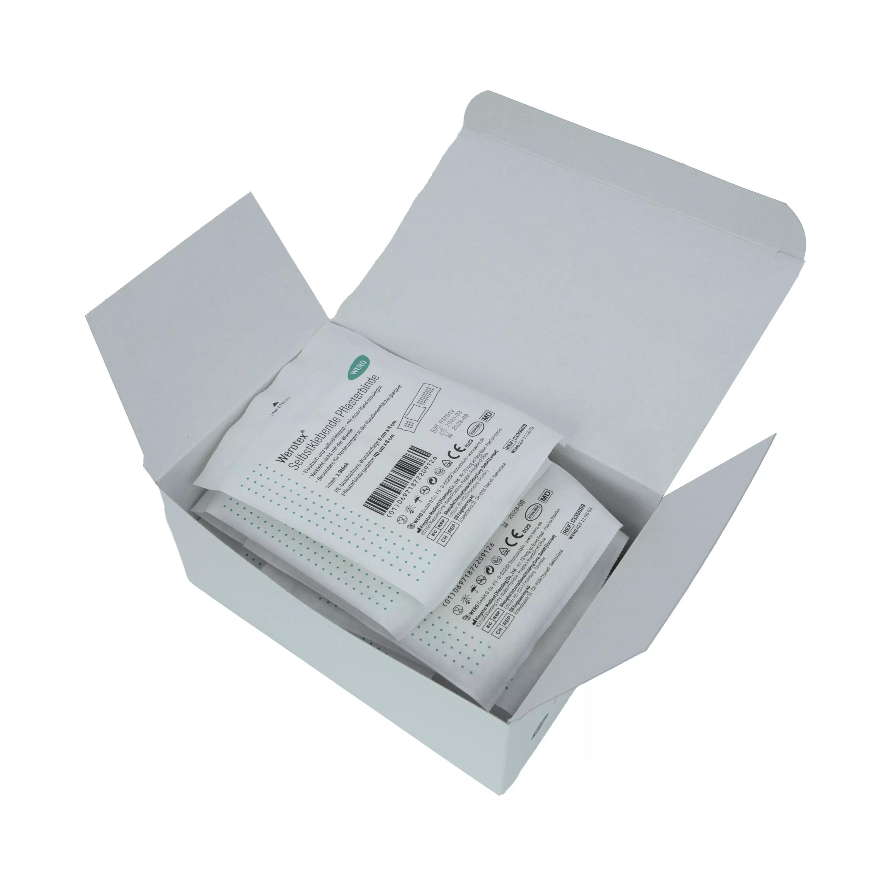 Zwei Packungen Werotex® selbstklebende Pflasterbinde, steril, liegen ordentlich in geöffneter weißer Box mit sichtbaren Produktlabeln.