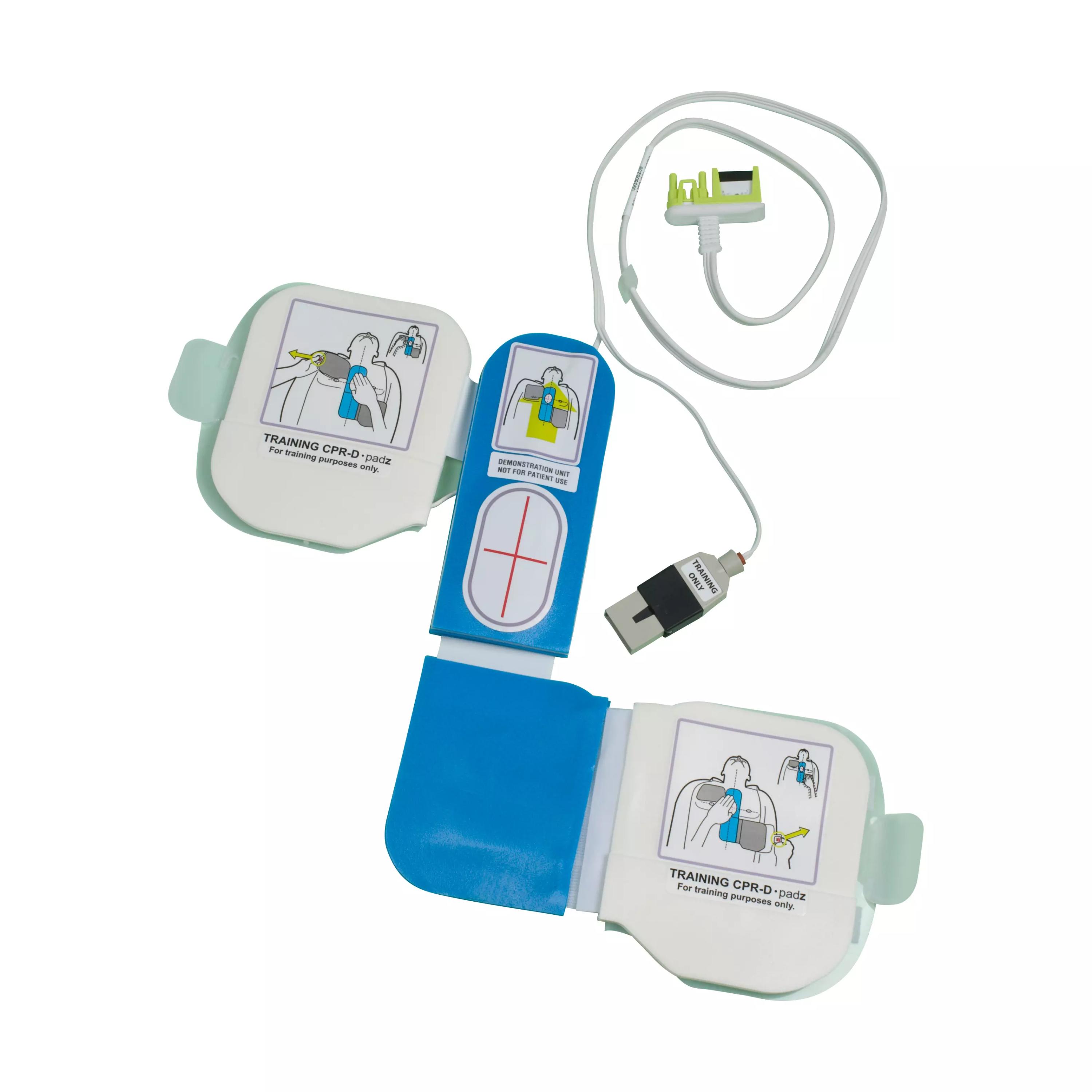 Demo-Elektrode CPR-D, blau-weißes Trainingsgerät mit zwei runden Sensoren und weißer Abdeckung mit bebilderter Anwendungsanleitung.