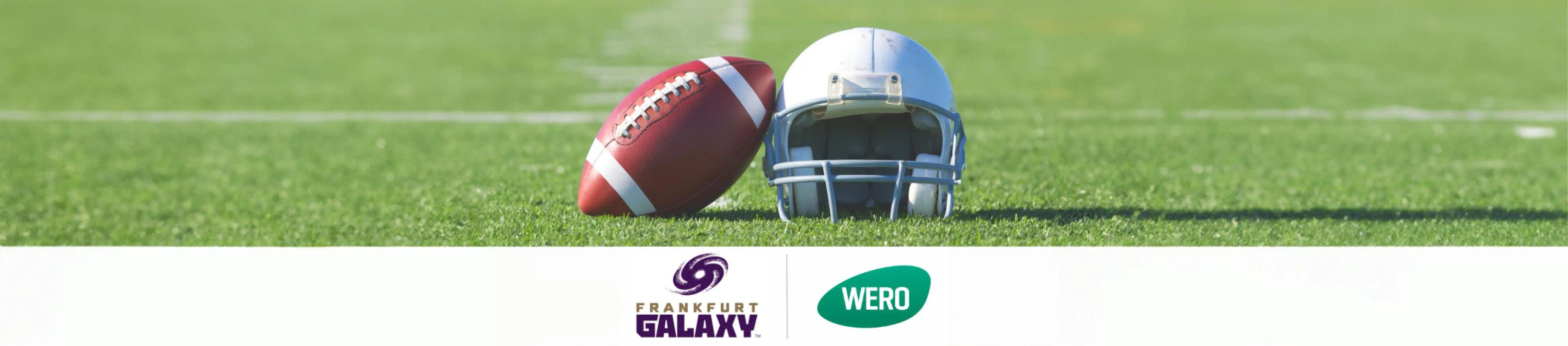 Ein Football sowie ein Football-Helm mittig auf einem Rasenplatz. Darunter die Logos von "WERO" und "Frankfurt Galaxy".