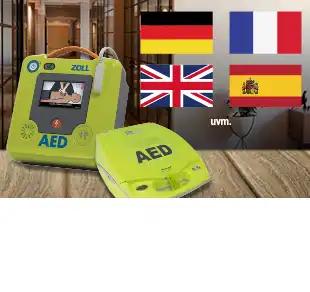 Grünes Zoll AED-Gerät mit Bildschirm und vier Flaggen für Deutsch, Französisch, Spanisch und Englisch, Kürzel UVM rechts unten