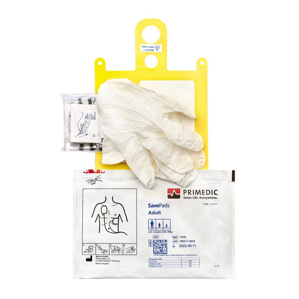 Gelbe Defibrillationselektroden Primedic SavePads für Erwachsene mit Anleitung und Zubehör wie Handschuhen sowie Ersatzpads im Beutel und Schere