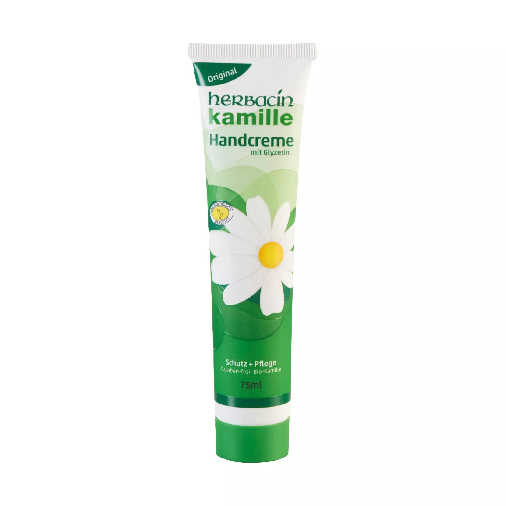 Eine 75-ml-Tube Kamille-Handcreme, Hautpflegecreme (W/O) mit grünem Deckel, zeigt eine weiße Kamille und die Aufschrift „Schutz + Pflege“.