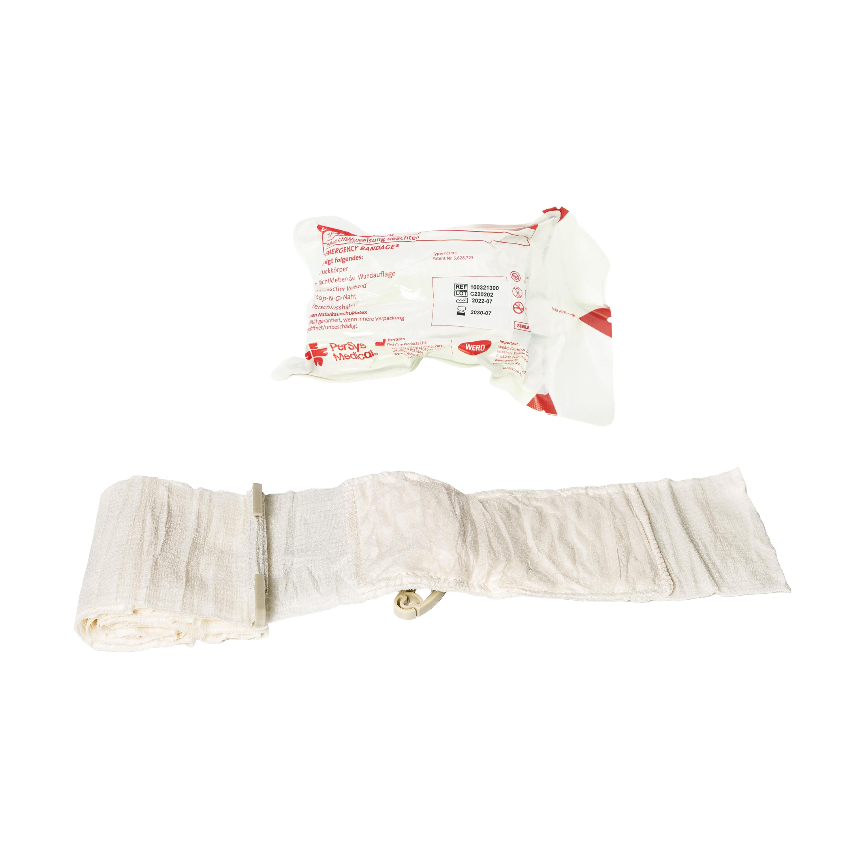 Alt-Text: Die Emergency Bandage®, das Original - Weiß, 10 cm, als aufgerollte Bandage mit Clip und separat verpacktem, rot-weiß beschriftetem Päckchen.