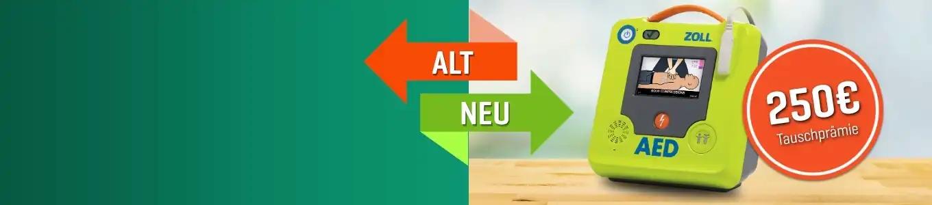 Limonengrüner AED mit Display „Medicamento“, rotem Preisschild und orangenen Pfeilen zwischen „ALT“ und „NEU“.