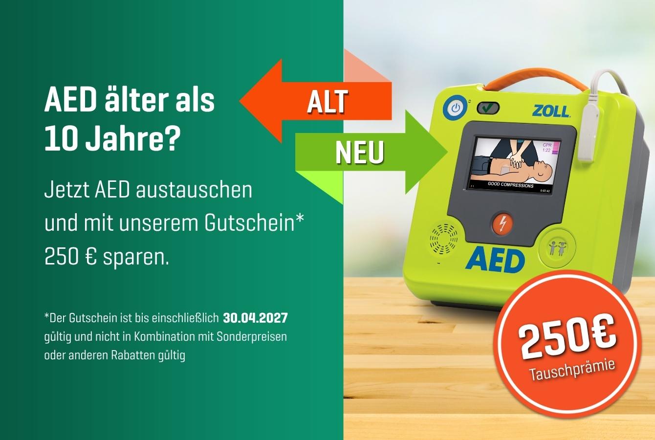 Grüner Zoll AED Defibrillator mit Bildschirm zeigt Schockanleitung, daneben Informationen zur Austauschprämie von 250 € und Datum 30.04.2027.