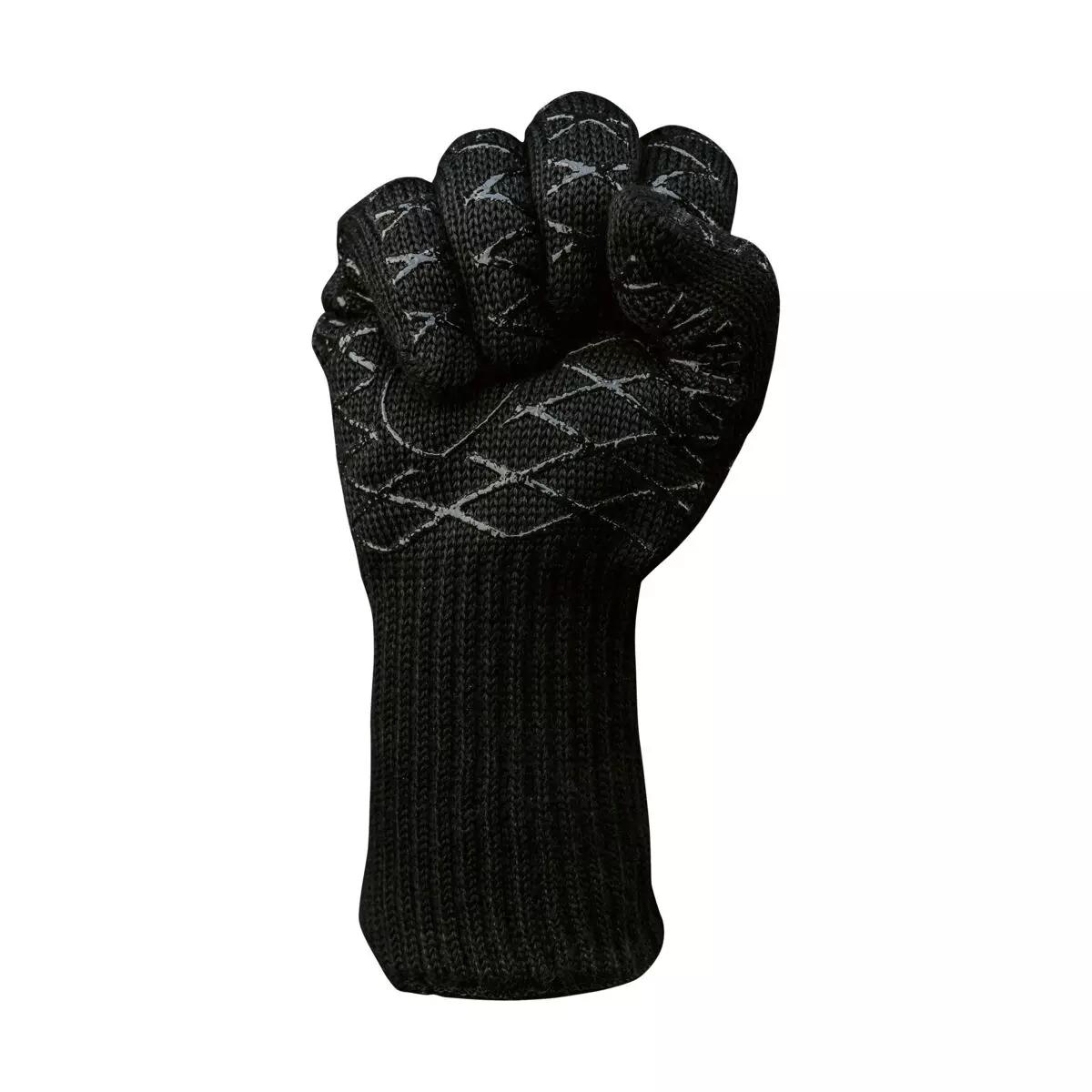 Ein Hitzeschutzhandschuh Aramid mit strukturierter Oberfläche und nötigem Schutz nach EN 388 und EN 407, Daumen und Finger leicht gekrümmt.
