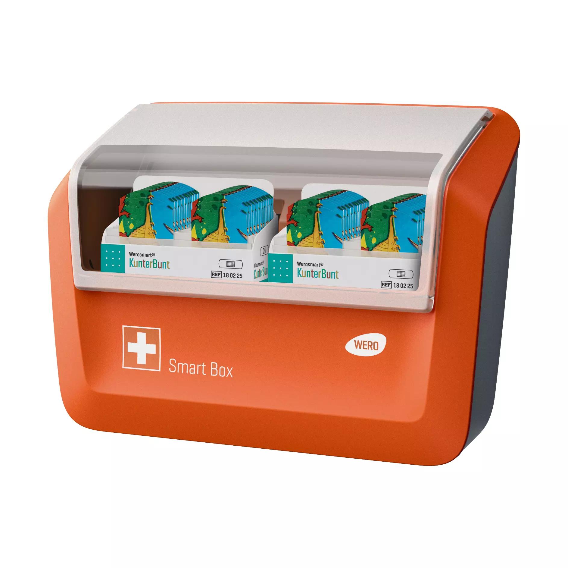 Eine WERO Smart Box® Pflasterspender gefüllt mit Werosmart KunterBunt Pflasterstrips für Kinder, orange-weiß, mit durchsichtigem Deckel und blauen Einzeleinsätzen.
