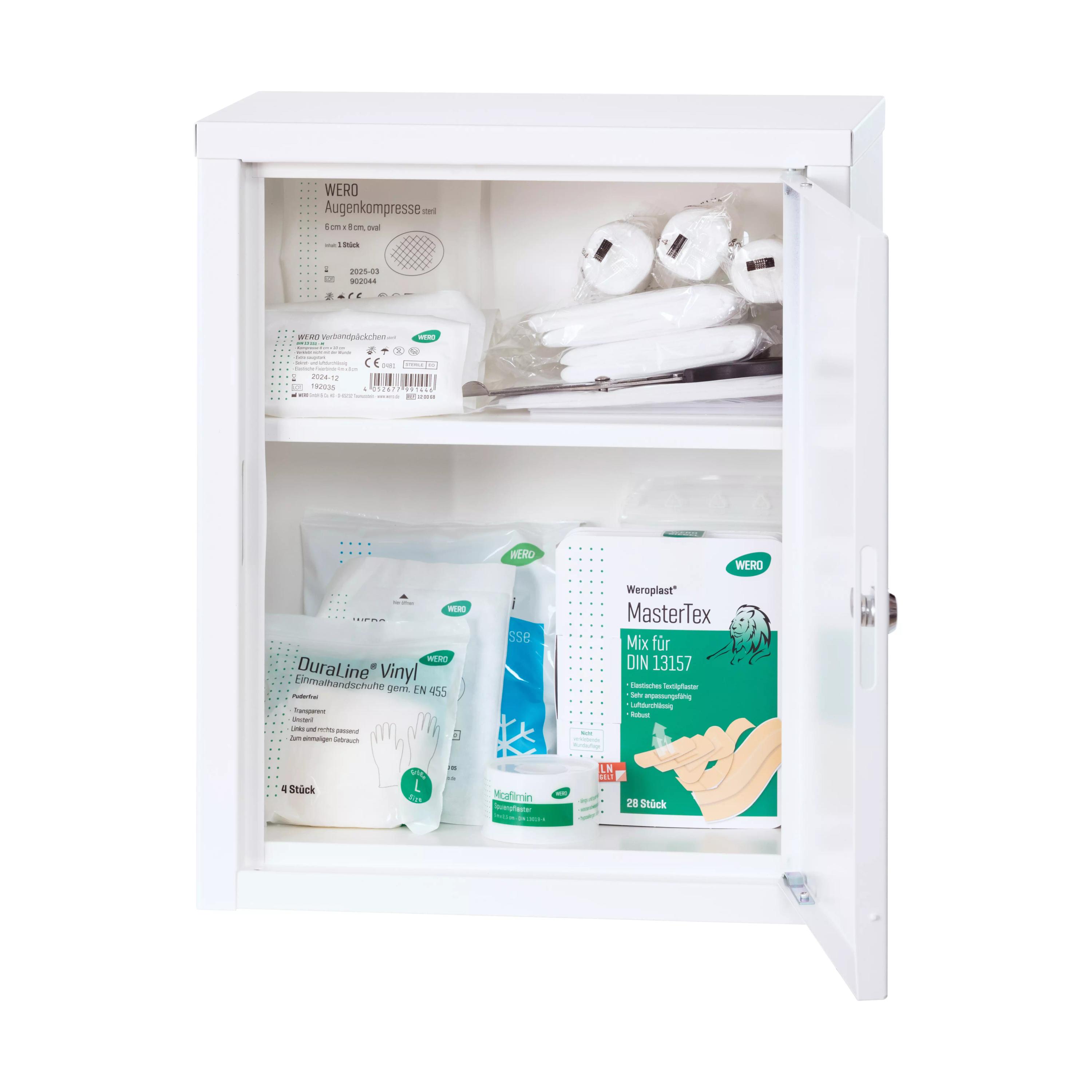 Ein runder, geöffneter WERO Verbandschrank MiniDuo 20 mit feststehendem Zwischenboden zeigt geordnet gelagerte medizinische Produkte.