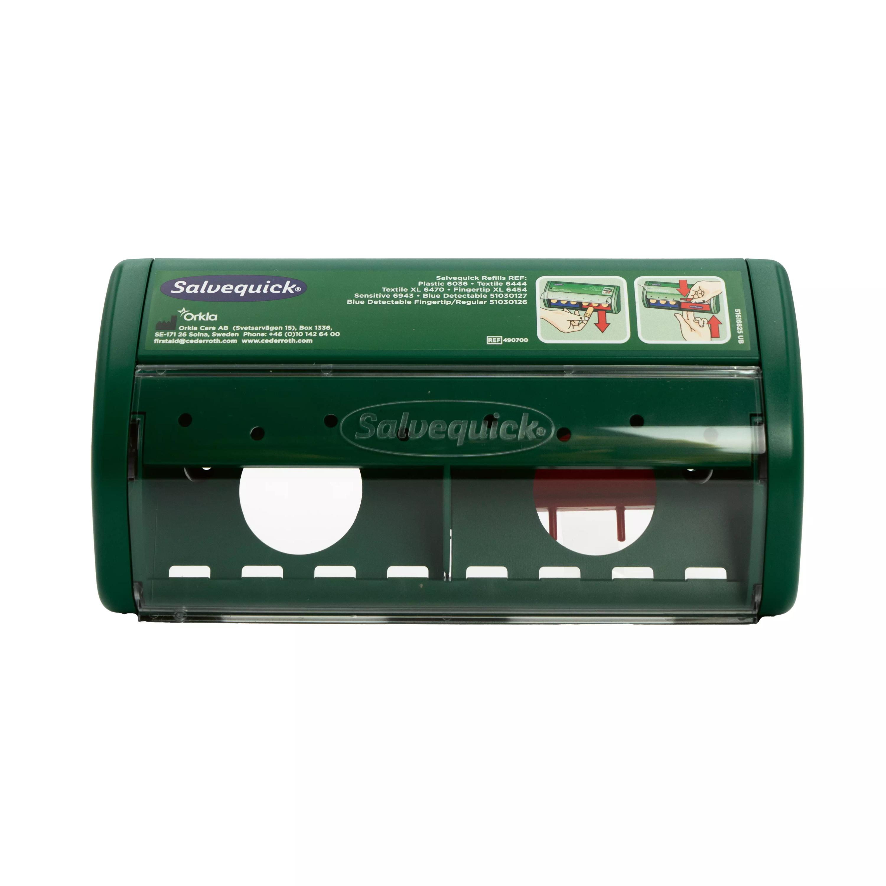 Grüner Salvequick® Sofortpflaster-Spender PRO, leer, mit Sichtfenster und zwei runden Entnahmeöffnungen auf der Vorderseite.