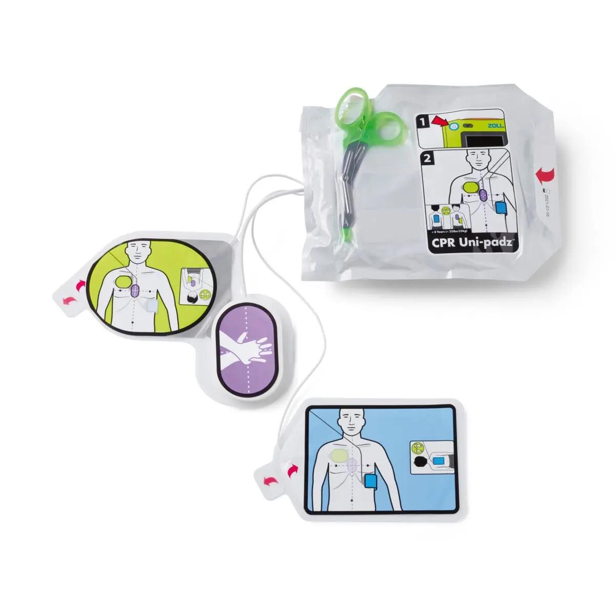 Defibrillator-Set ZOLL® AED 3, Vollautomat mit CPR Uni-padz® für Erwachsene und Kinder, zwei Scheren und Anleitung auf weißer Verpackung.