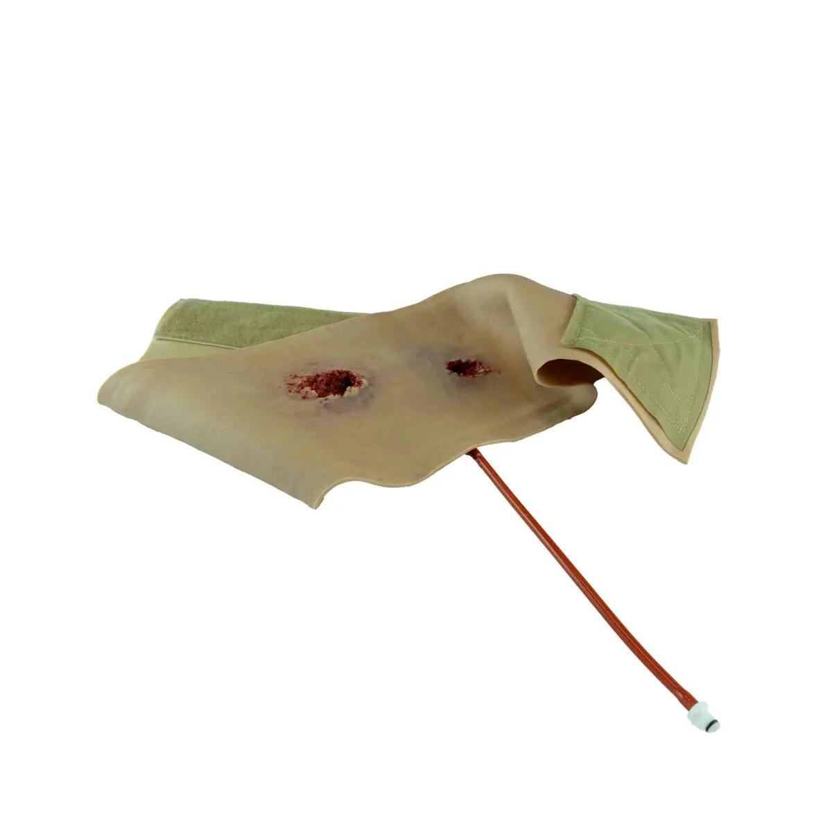 Techline Moulage Schusswunde Bein mit simuliertem Schusskanal, freigelegtem Fett und Muskeln sowie grünem Haltegurt und Anschluss-Tubus.