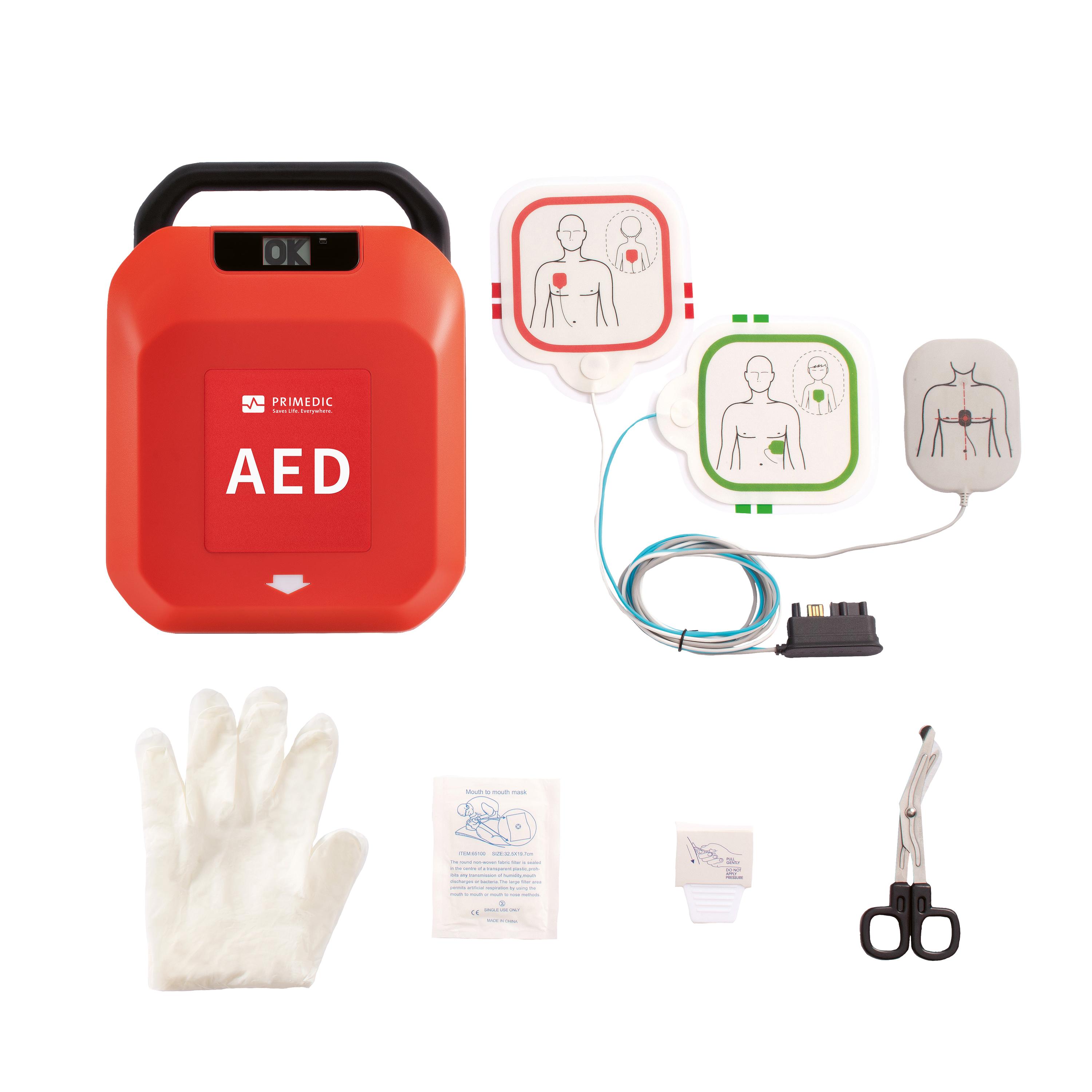 Defibrillator-Set HeartSave Y/YA in Rot-Weiß mit AED-Gerät, weißem Handschuh, schwarzen Scheren sowie Elektrode und Zubehör übersichtlich angeordnet.