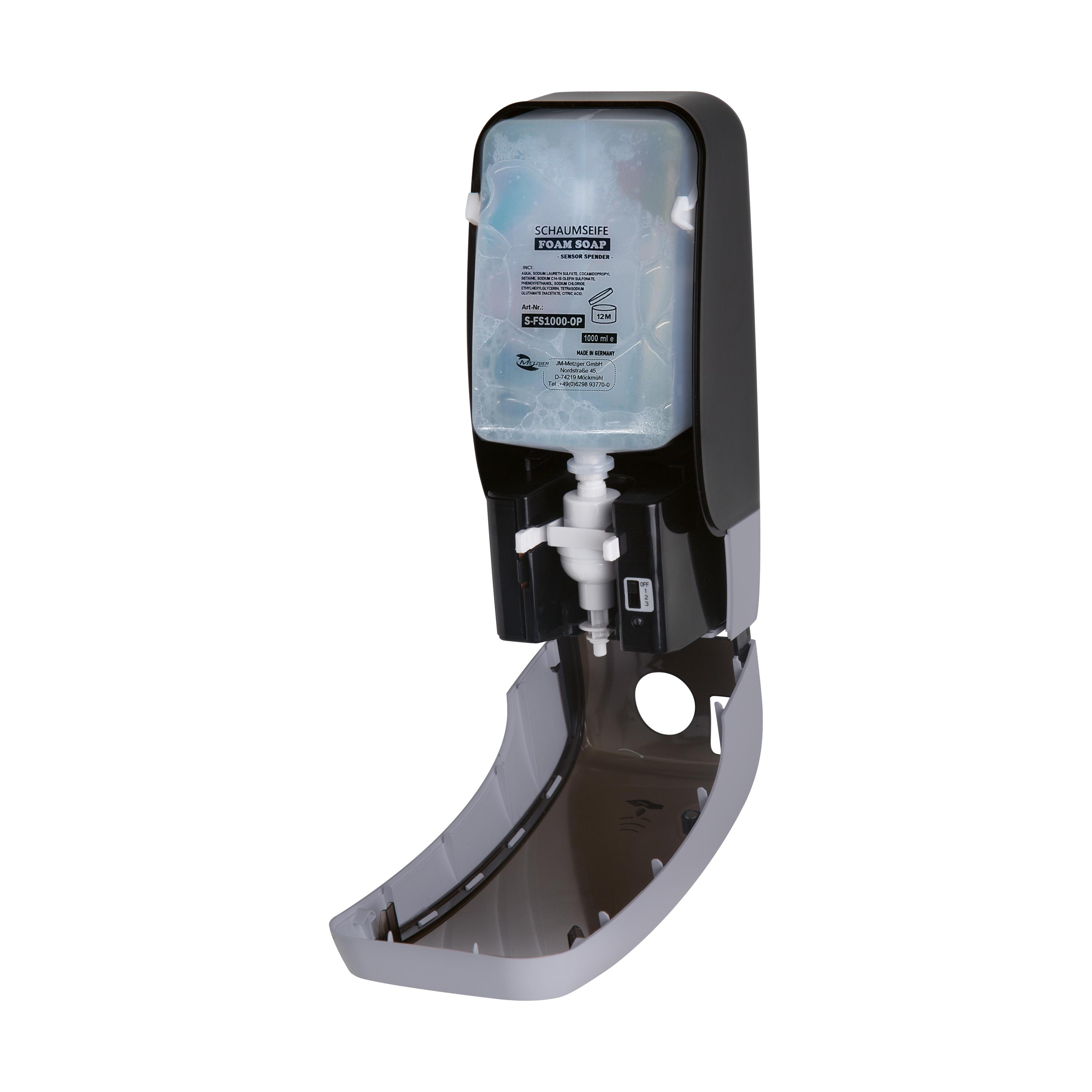 Grauer Sensorspender Sensorschaumseife RATIO – parfümiert mit schwarzem Deckel, weißer Auslassdüse und sichtbarem 1000-ml-Reservoir mit Produktetikett.