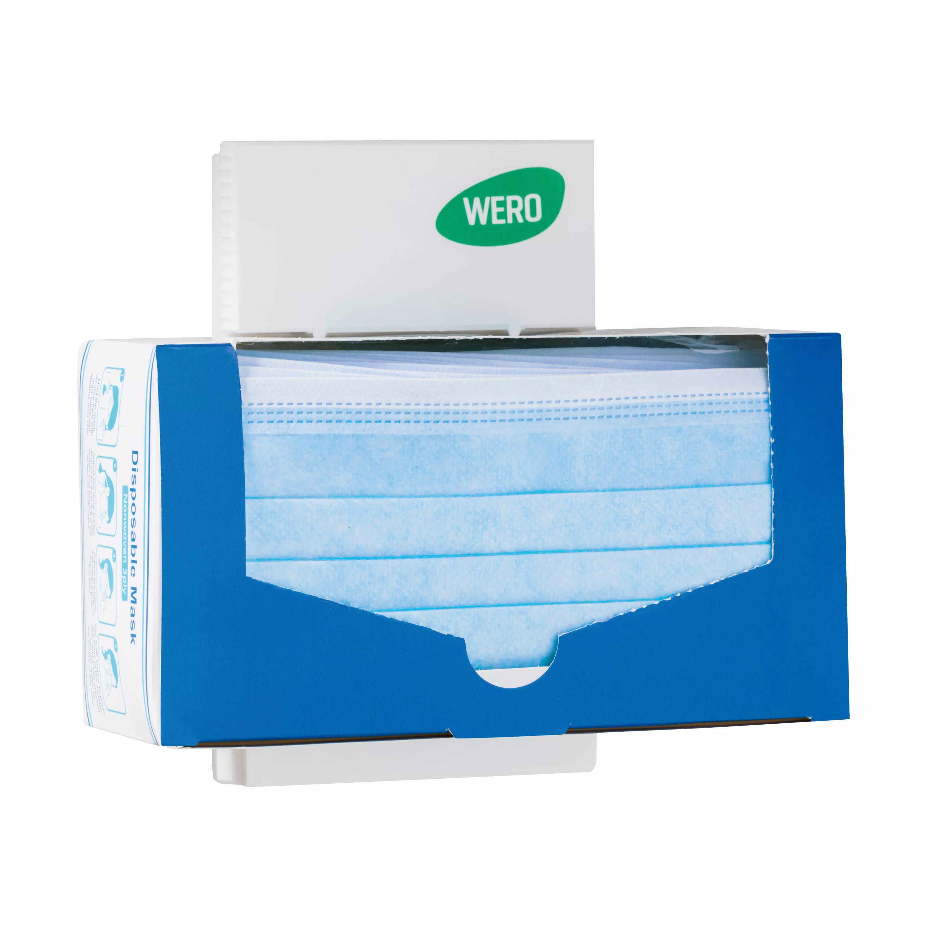WERO Universalhalter aus Kunststoff ist an einer Wand befestigt und hält eine geöffnete Box mit blauen Einwegmasken, die seitlich entnommen werden können.