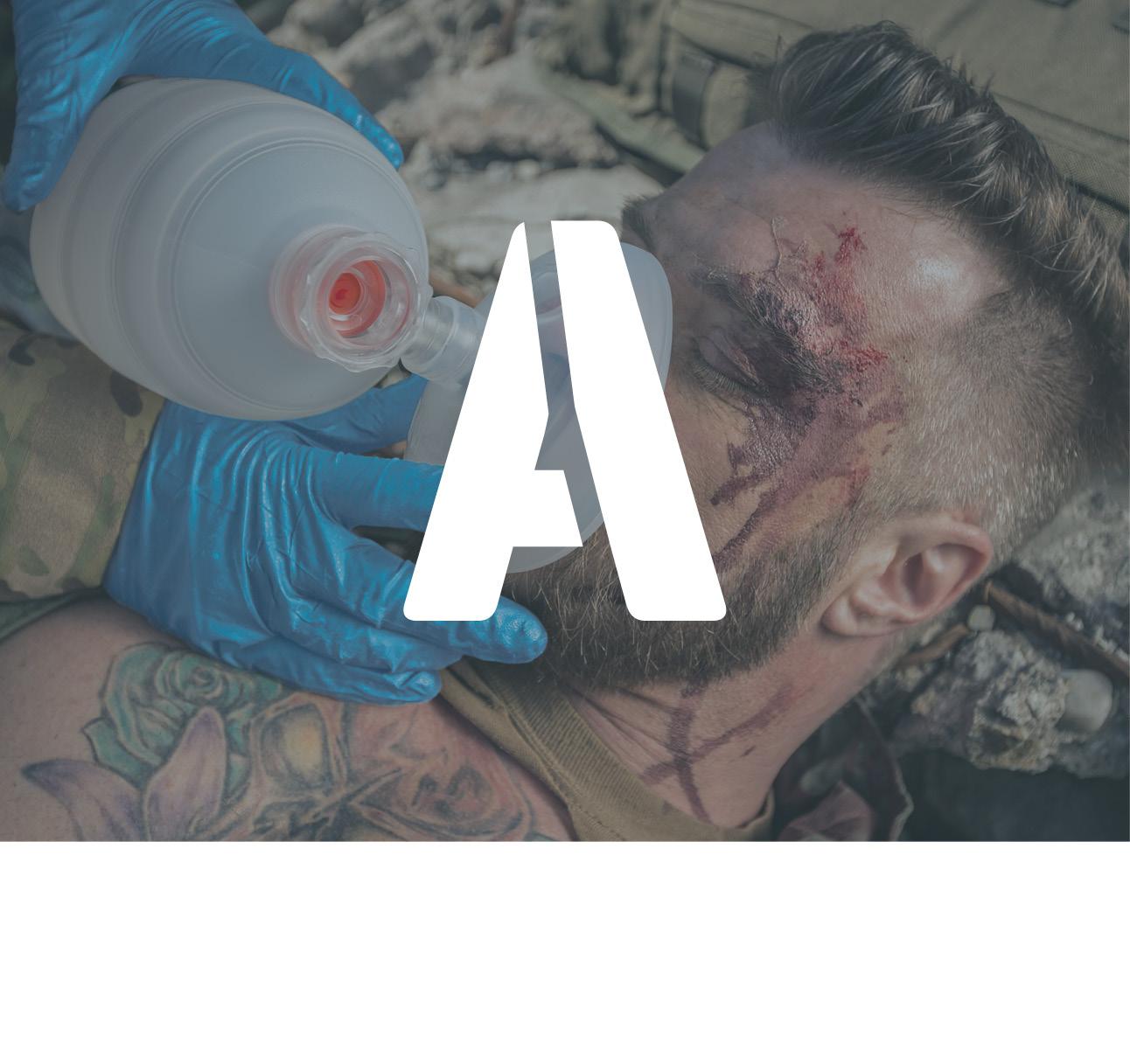 Ein Soldat wird mit einem Beatmungsbeutel beatmet. Im Vordergrund ein weißes "A".