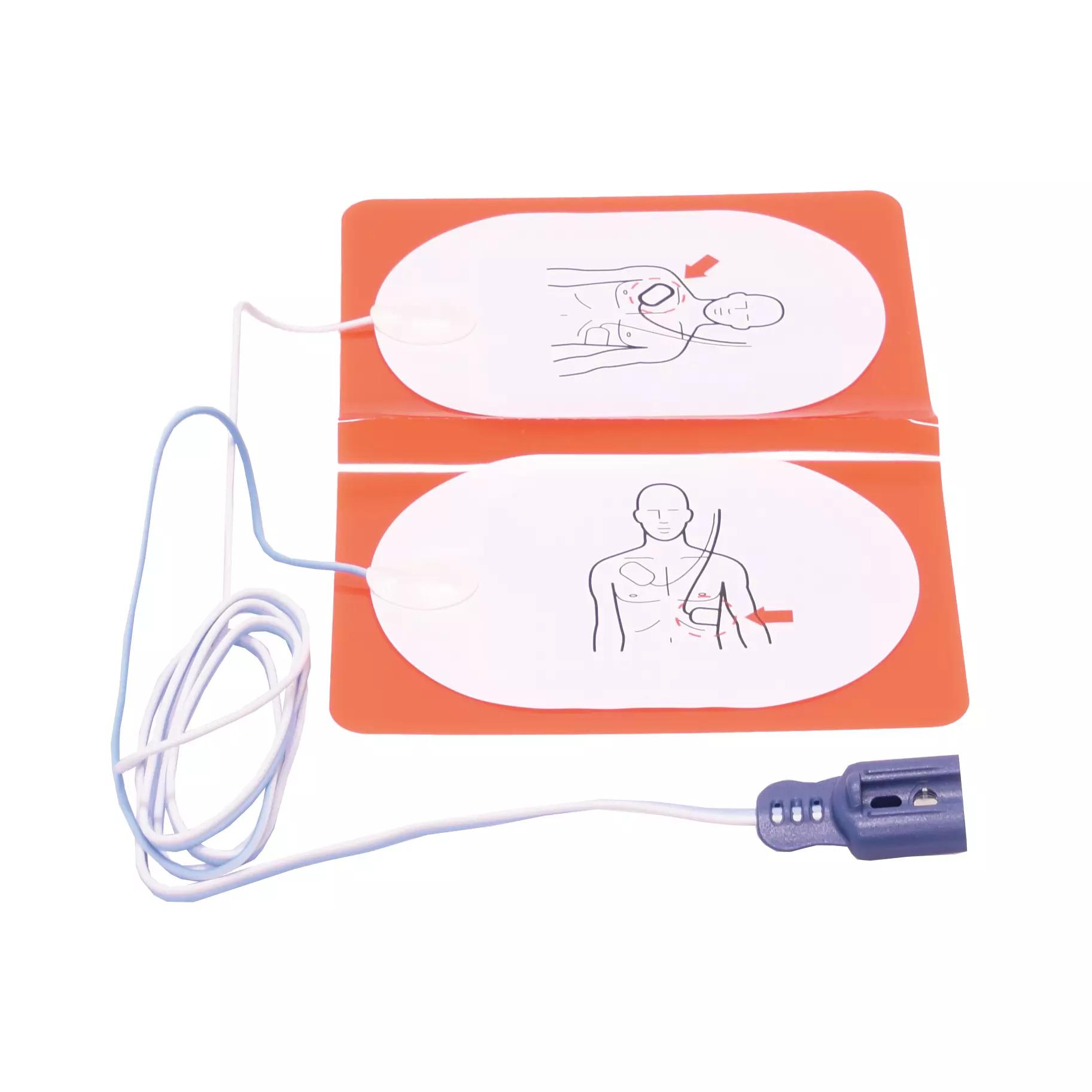 Zwei orange Defibrillationselektroden für Erwachsene für Philips Heartstart FR2/FR2+ mit weißen Diagrammen und angeschlossenem Kabel.